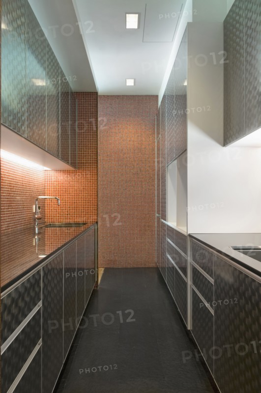 Modern kitchen with cabinets and mosaic tile wall