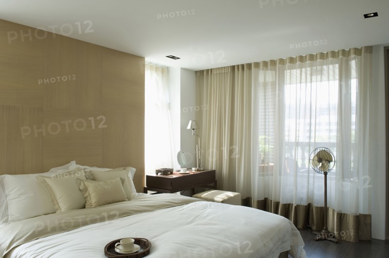 Light colored pillows and comforter on bed