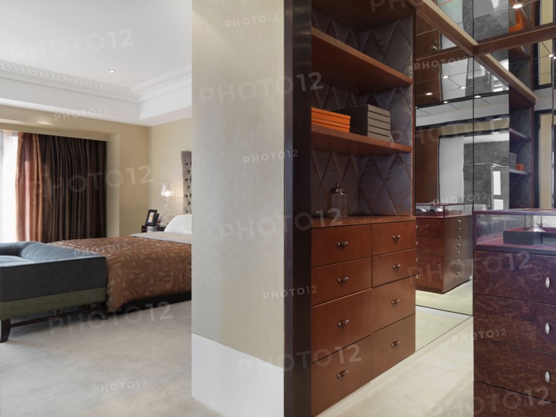 Dresser and shelving outside of modern master bedroom