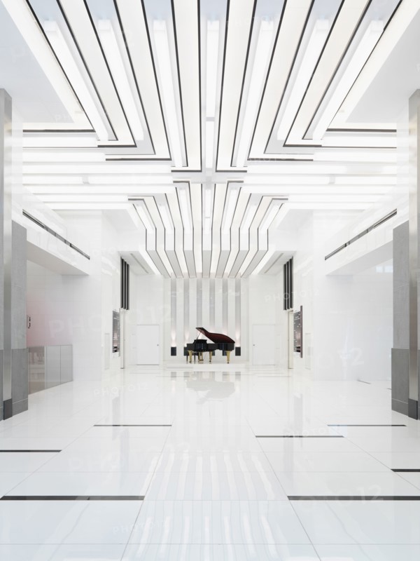 Baby grand piano in bright white room