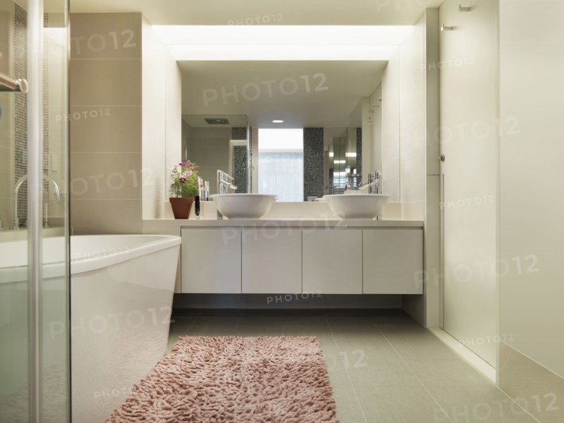 Light colored modern bathroom with large bathtub