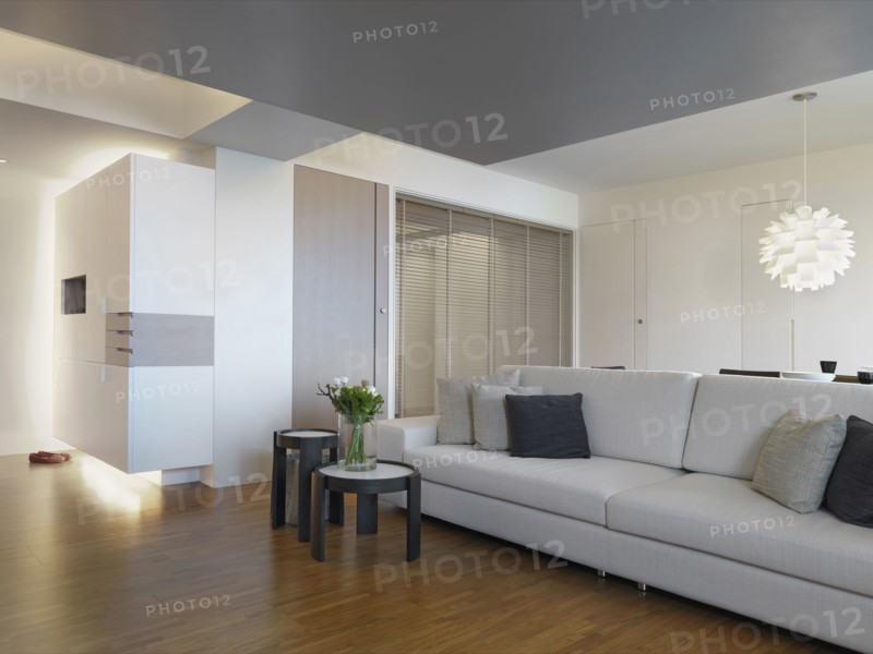 Gray sofa in living room with hardwood floors