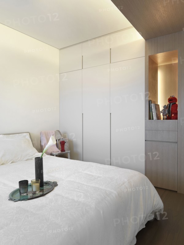 Serving tray on end of white bed