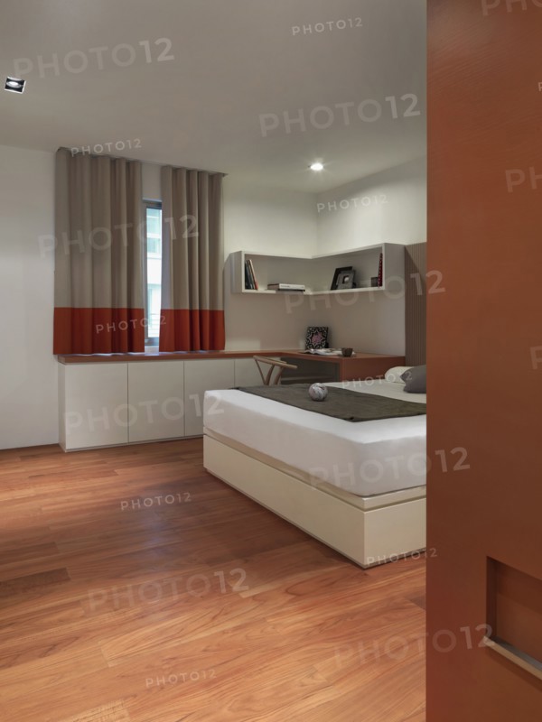 Bed in bedroom with hardwood floor