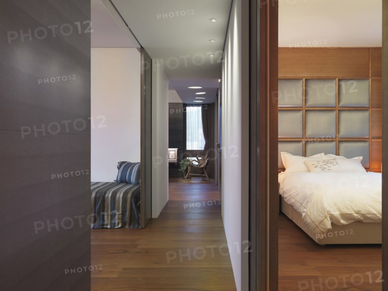 Hardwood hallway between bedroom and living room in modern home