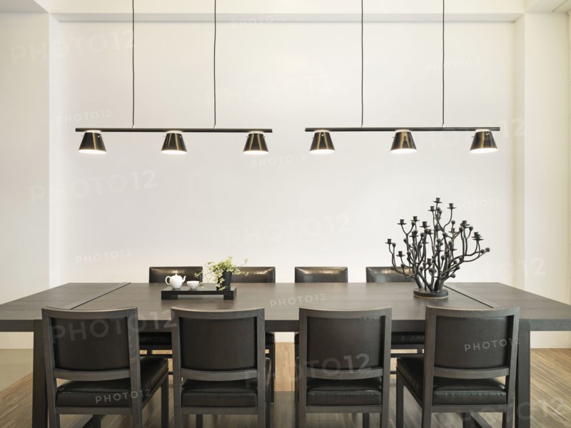Simple dining table in modern home with hanging lights