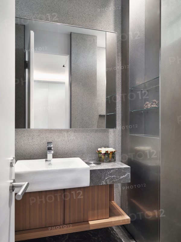 White sink on marble countertop in bathroom