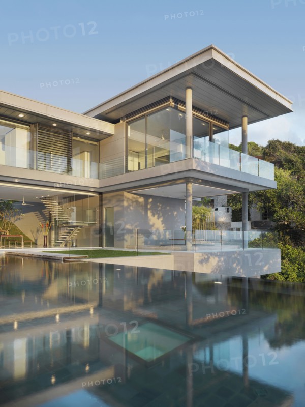 Multiple story modern home with swimming pool out front