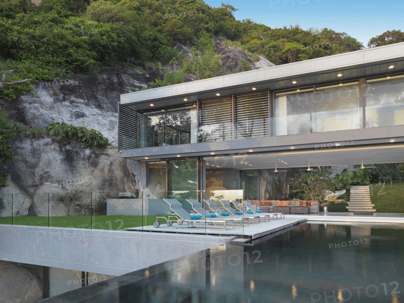 Multiple story modern home with swimming pool out front