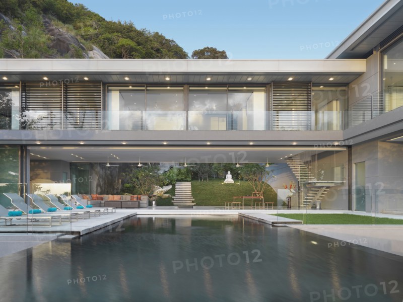 Multiple story modern home with swimming pool out front