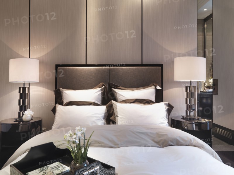Serving tray on foot of bed in modern home