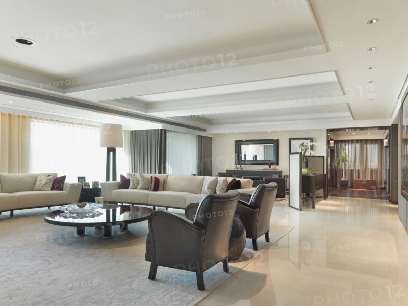 Modern living room with white sofas and black armchairs