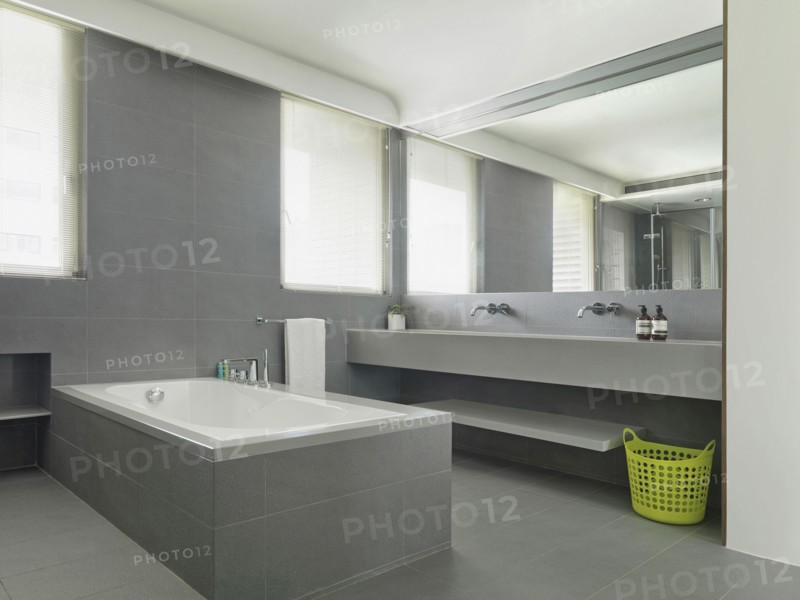 Minimalistic gray bathroom with large mirror