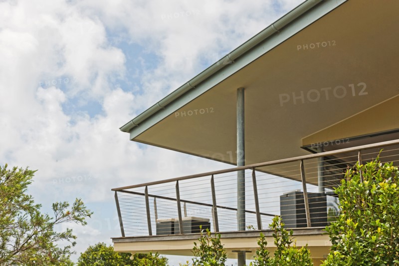 Balcony of residential building against cloudy sky