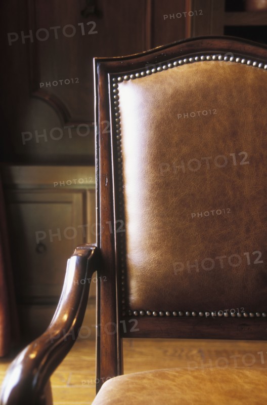 Brown leather and wood armchair