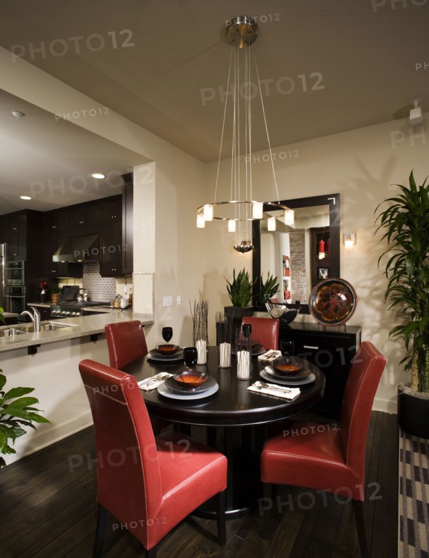 Circular dining table with red leather chairs