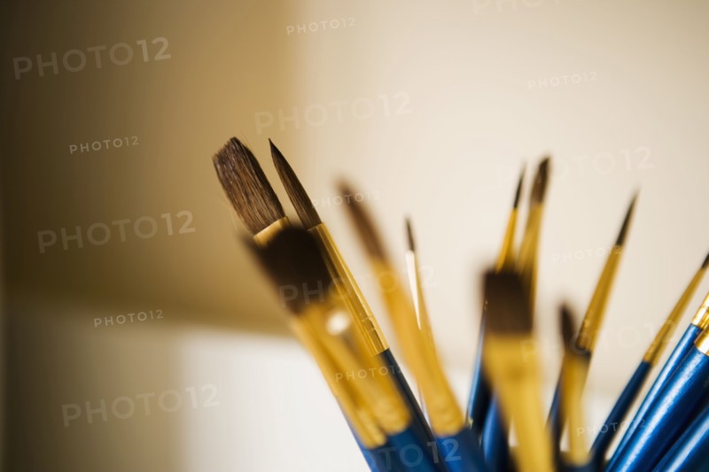 Blue and Gold Paintbrushes in a Jar