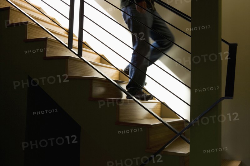 Moody Detail of Person Descending Modern Stairs