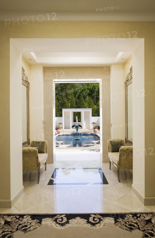 Interior of a marble hallway leading to a pool