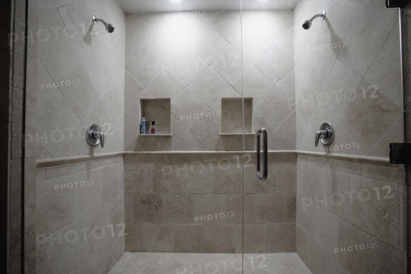 Detail of dual stone showers with glass door