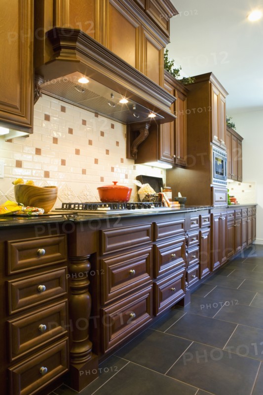 Custom kitchen cabinetry with hood.