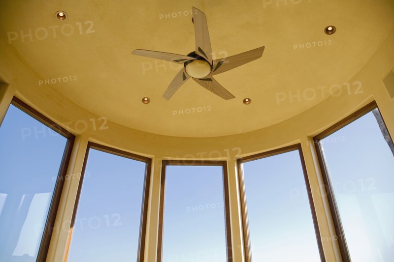 Detail of large bay windows and ceiling fan