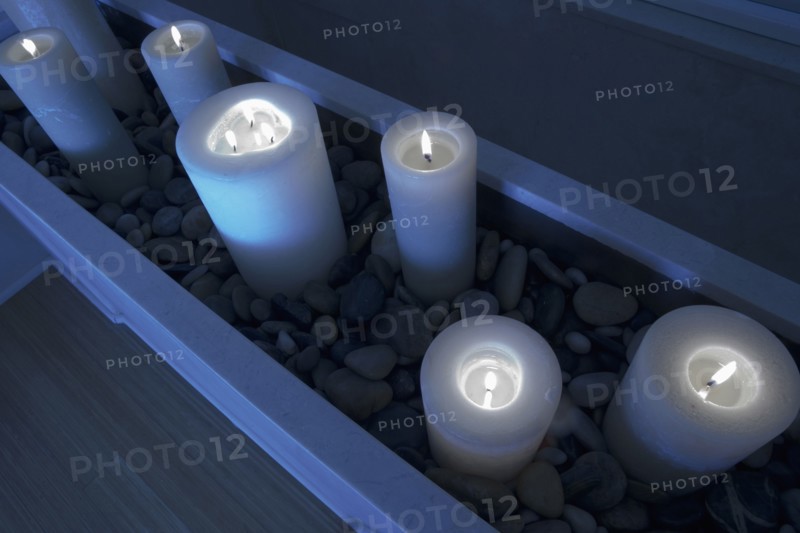 Night scene with lit candles in stones