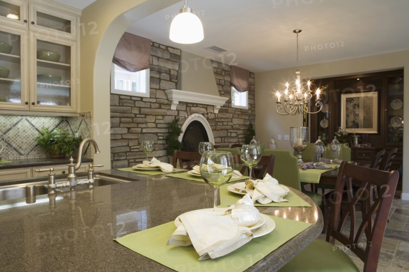 Kitchen with breakfast bar and dining room with stone wall