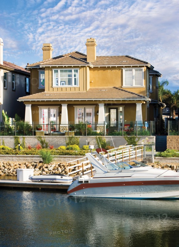Exterior of one story house with speedboat in lake