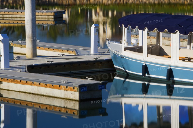Boats docked at housing community near channel to ocean