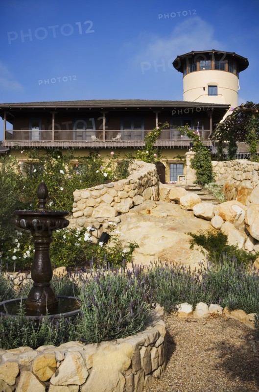 Stone steps leading up to a large spanish style home