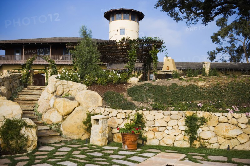 Stone steps leading up to a large spanish style home