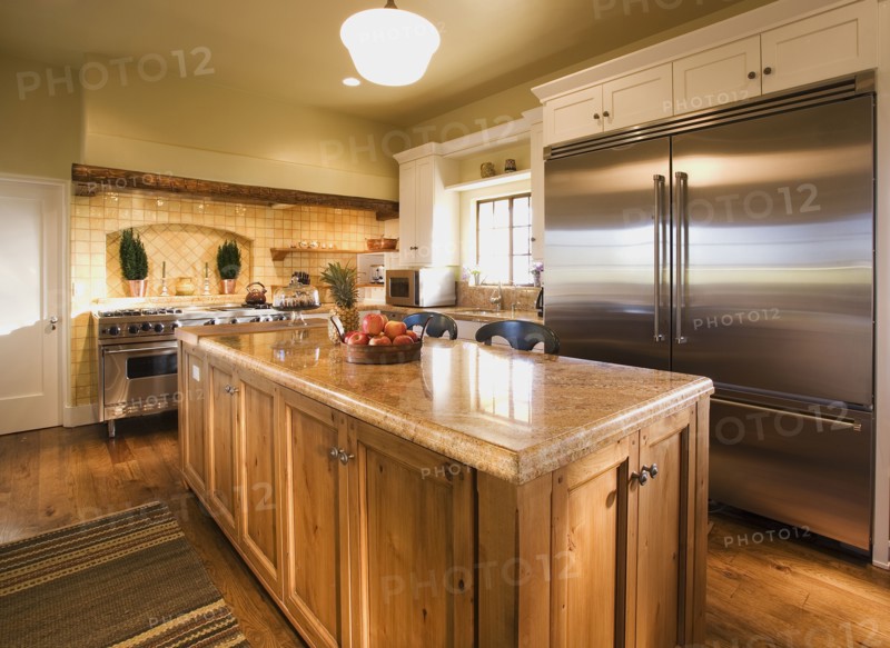 Interior of Kitchen with Island and large stainless steel refrigerator