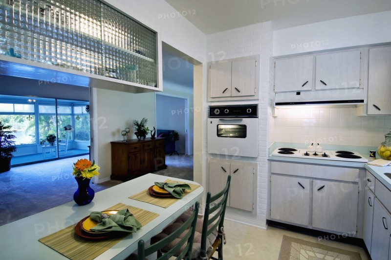 Place settings at breakfast bar in retro kitchen