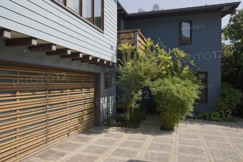 Wooden garage door and blue sided home