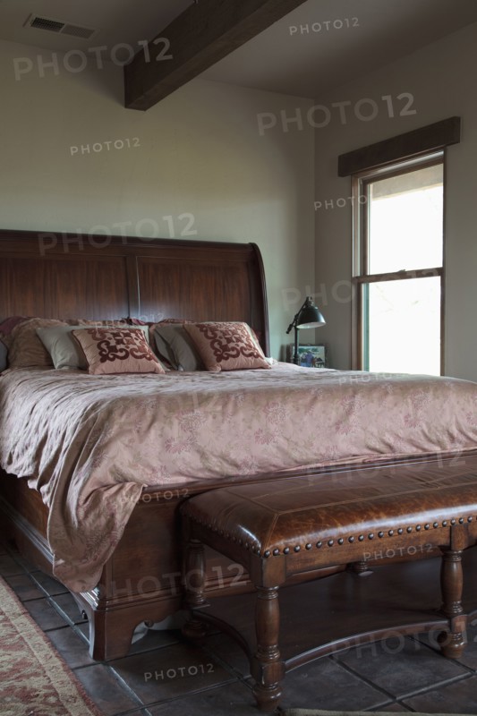 Leather bench at foot of master bed