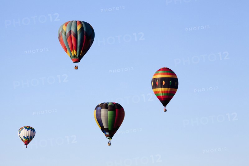 Hot air balloons floating in blue sky