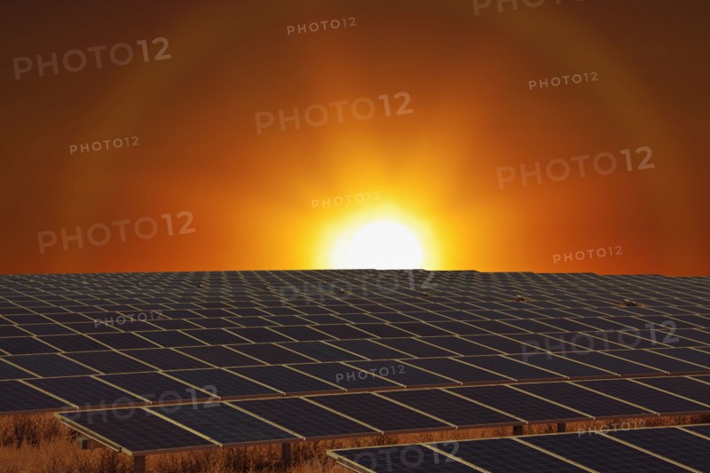 Sunset over field of solar panels