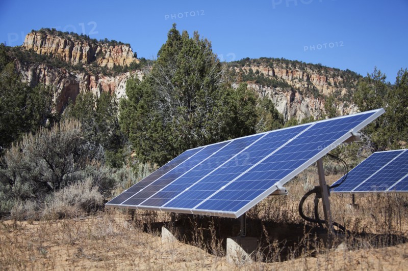 Solar panels in remote field near mountains