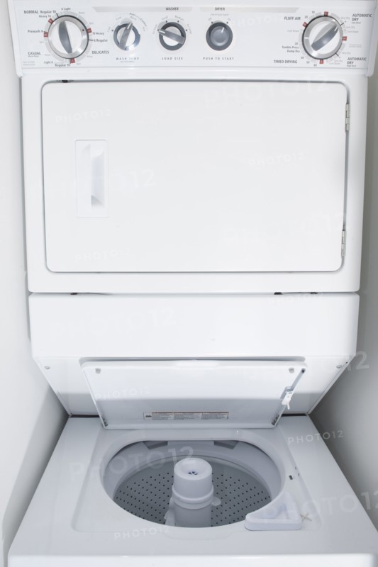 Close up of empty stacking washing machine and dryer