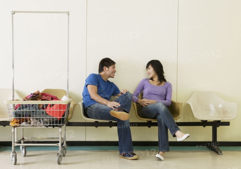 Asian couple in laundromat