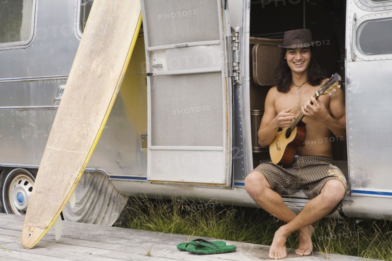 Pacific Islander man playing ukulele