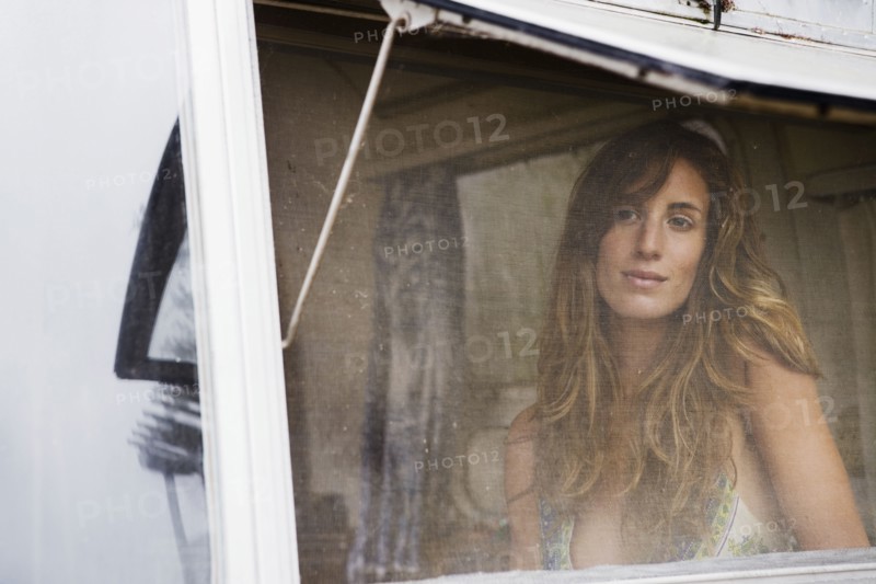 Mixed race woman looking through screen
