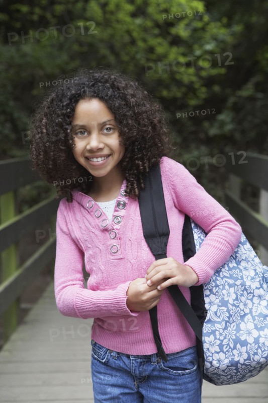 Mixed race girl walking with backpack