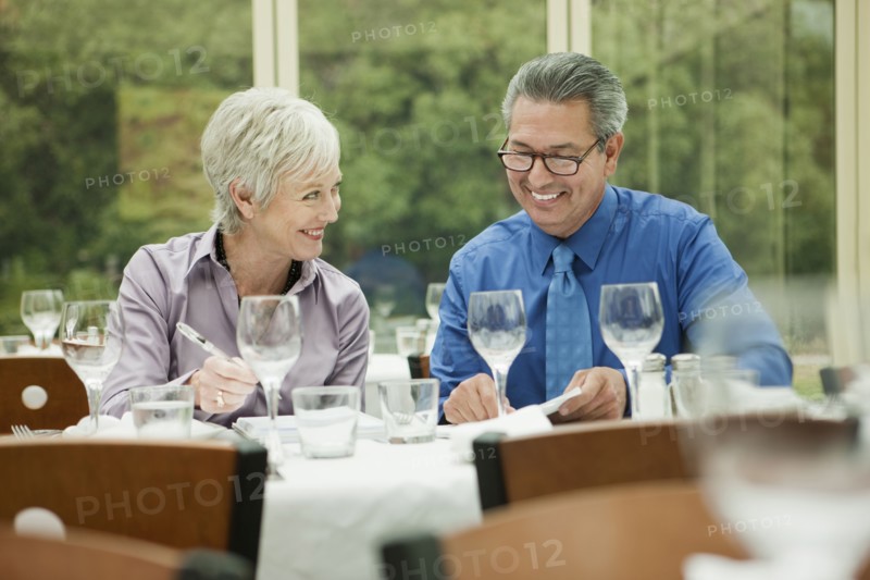 Business people working at table in restaurant