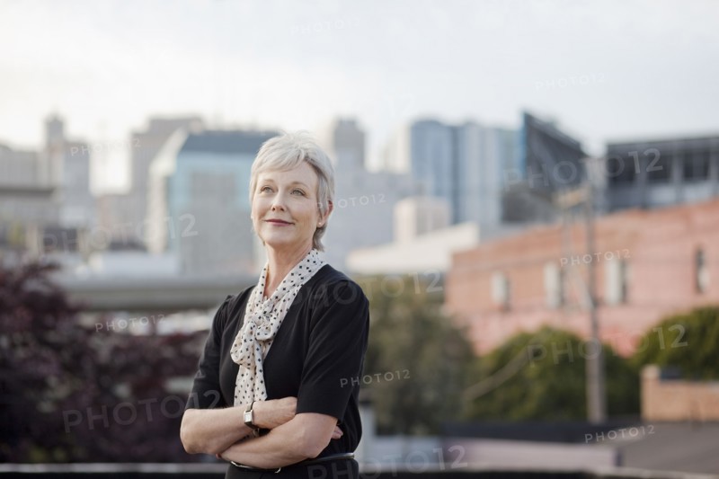 Portrait of pensive Caucasian businesswoman posing outdoors