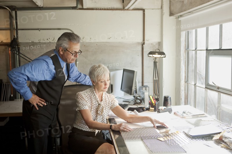 Business people examining parts in office
