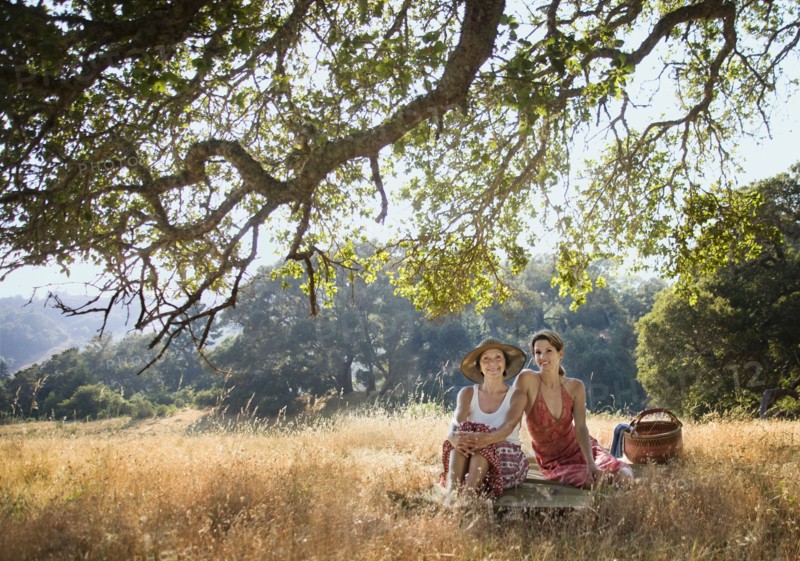 Portrait of smiling women relaxing on picnic blanket