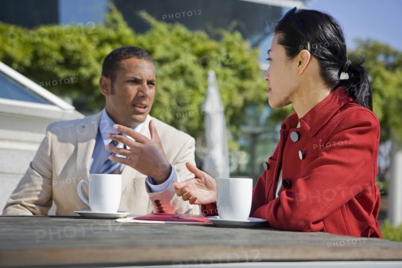 Business people talking and drinking coffee outdoors