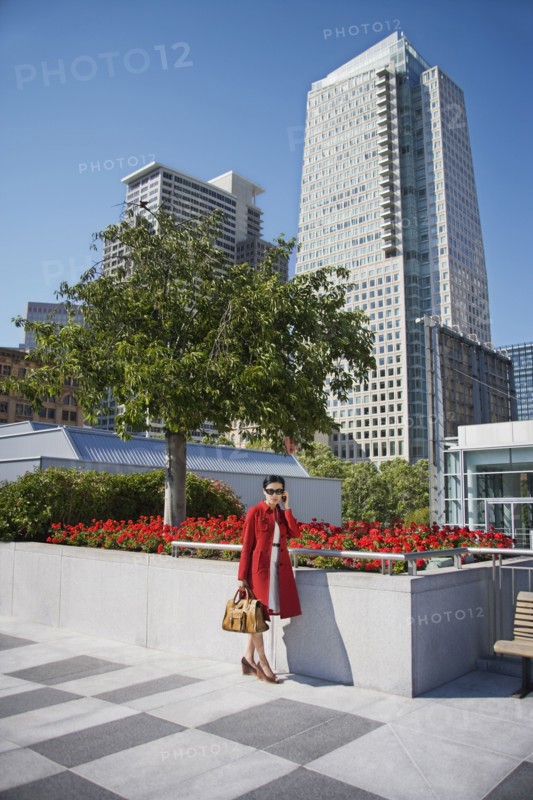 Asian businesswoman talking on cell phone outdoors